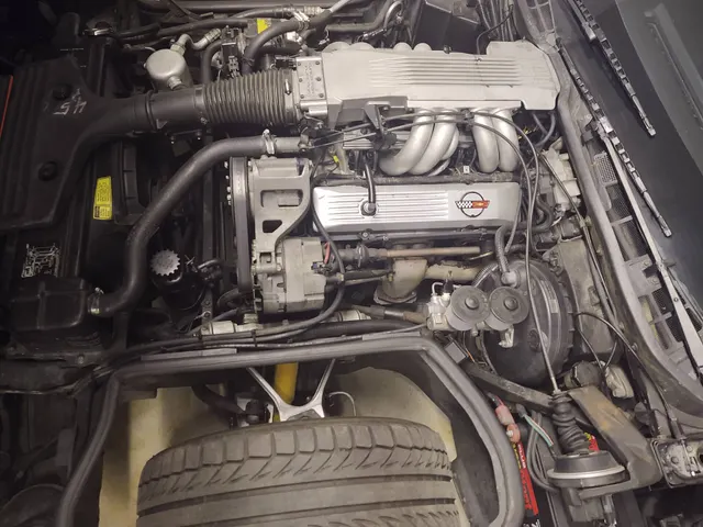 Exact-year L98 engine bay retained for Tuned Port Injection plenum, runners, intake plumbing, accessory, cooling, and emissions context; one car's stamp, dates, and equipment remain subject-specific.