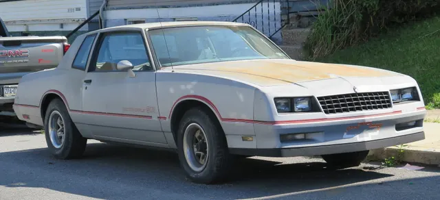 Exact-year Silver Metallic Monte Carlo SS front-quarter view retained for the SS nose, front fascia, striping, badging, roofline, side moldings, factory wheels, and stance; visible weathering and condition remain specific to this car.
