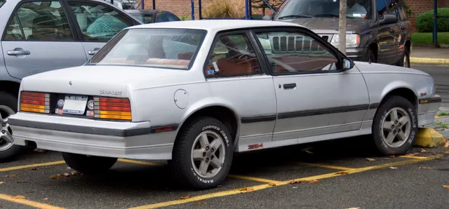 Exact-year rear-quarter view retained for the Z24 coupe roofline, rear glass, deck, lamps, bumper, lower cladding, badges, wheels, and body proportions; condition and tires remain specific to the photographed car.