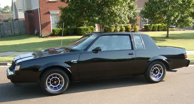 Exact-year side profile retained for the coupe roof, door, quarter, wheel openings, fender emblem, chrome sport wheels, ride height, glass, and body proportions; tire and condition details remain car-specific.