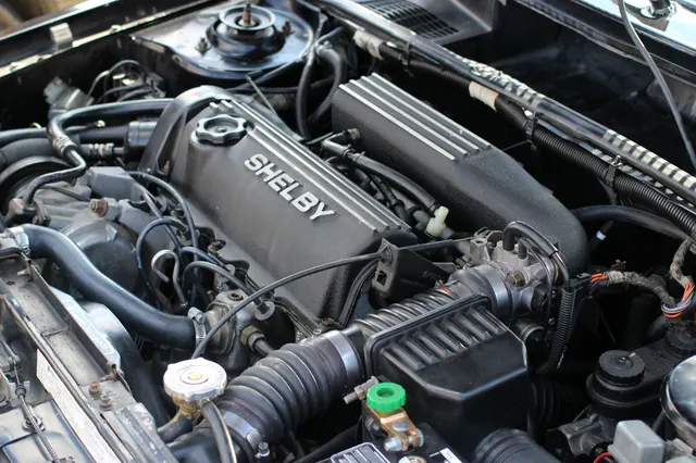 Exact-year Shelby GLHS engine bay retained for visible turbo-engine layout and underhood component context; condition and service changes remain specific to the photographed car.