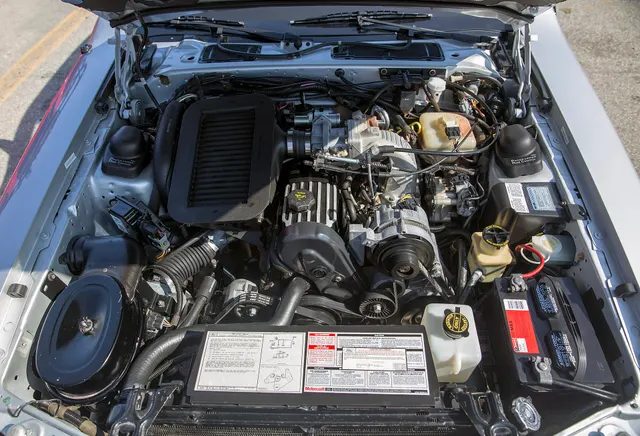 Exact-model-year Turbo Coupe engine bay retained for intercooled turbo, induction, plumbing, accessory, and installation context; condition and service parts remain car-specific.