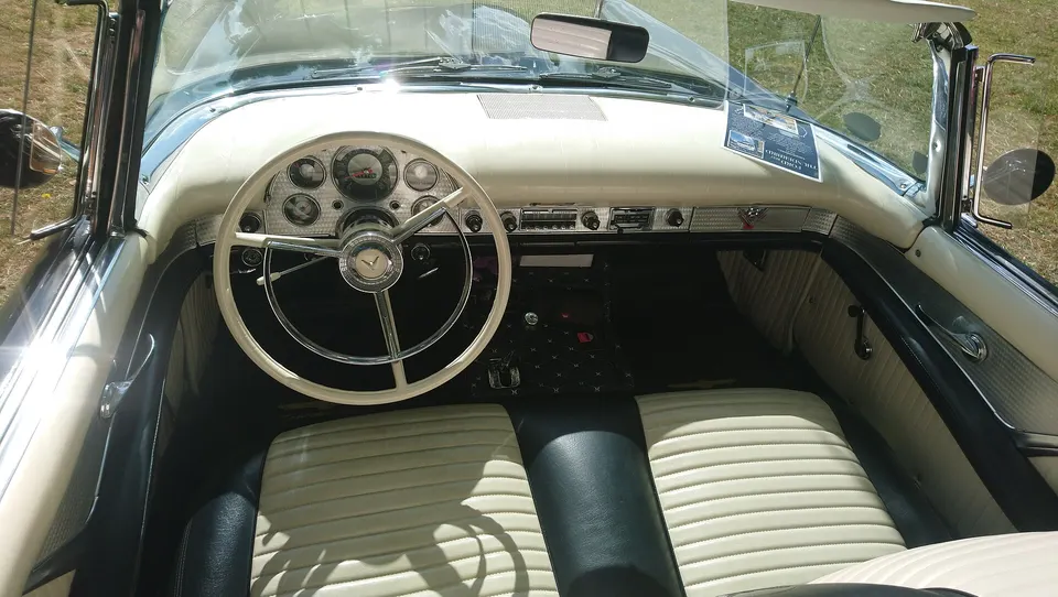 Full-width padded instrument panel with coordinated engine-turned door trim profile photo