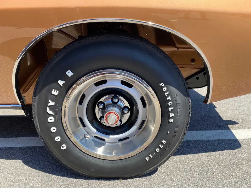 14x6 slot-style wheels with E70-14 raised-white-letter tires profile photo